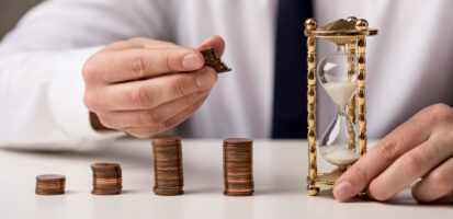 front-view-businessman-with-coins-hourglass